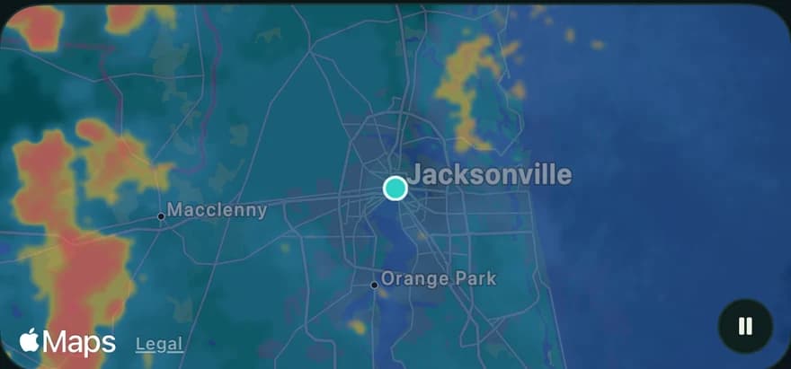 The conditions map in the app: a radar loop over Jacksonville with heavy rain to the west, and a play control for the timeline.